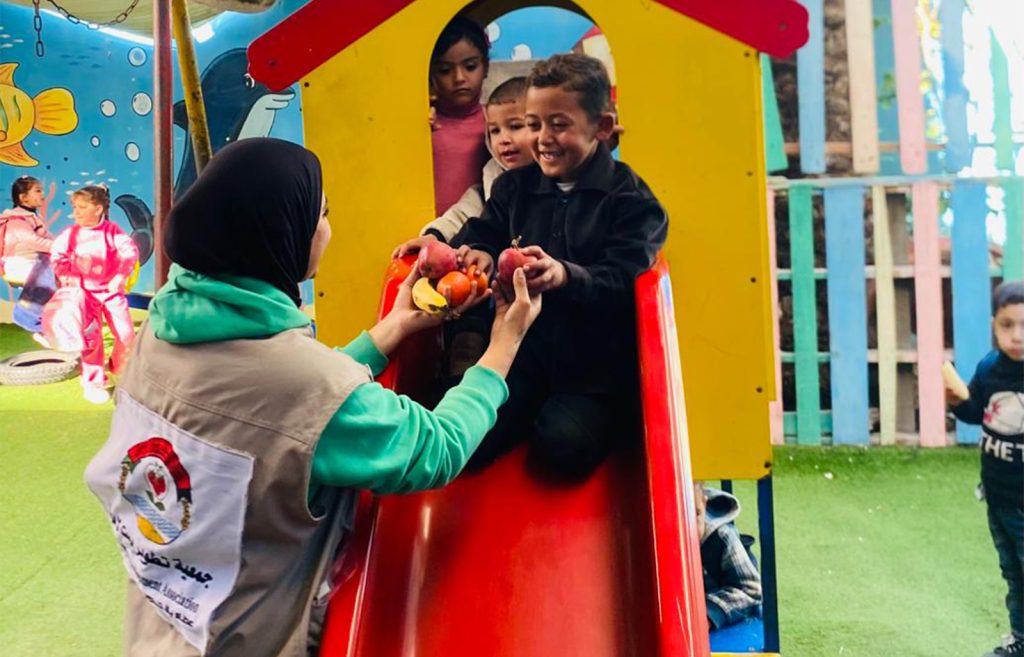 Distribution of fruit baskets to children in Deir al-Balah, supported by (WCK)