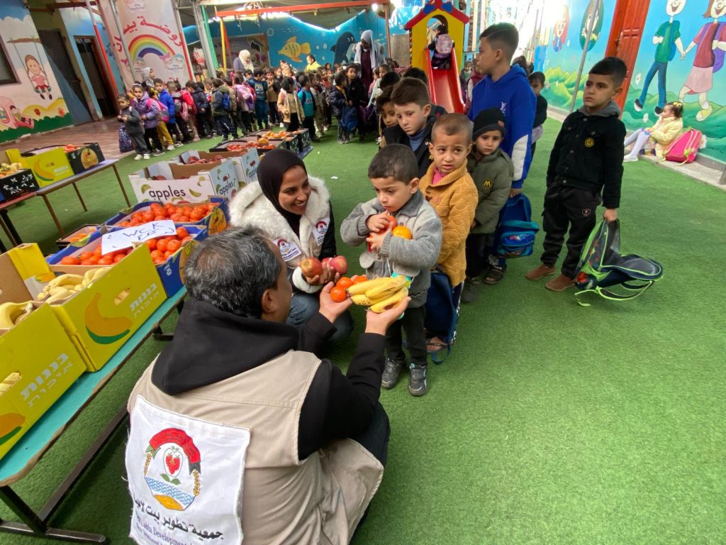 Distribution of fruit baskets to children in Deir al-Balah, supported by (WCK)