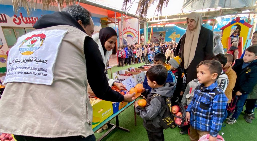 Distribution of fruit baskets to children in Deir al-Balah, supported by (WCK)